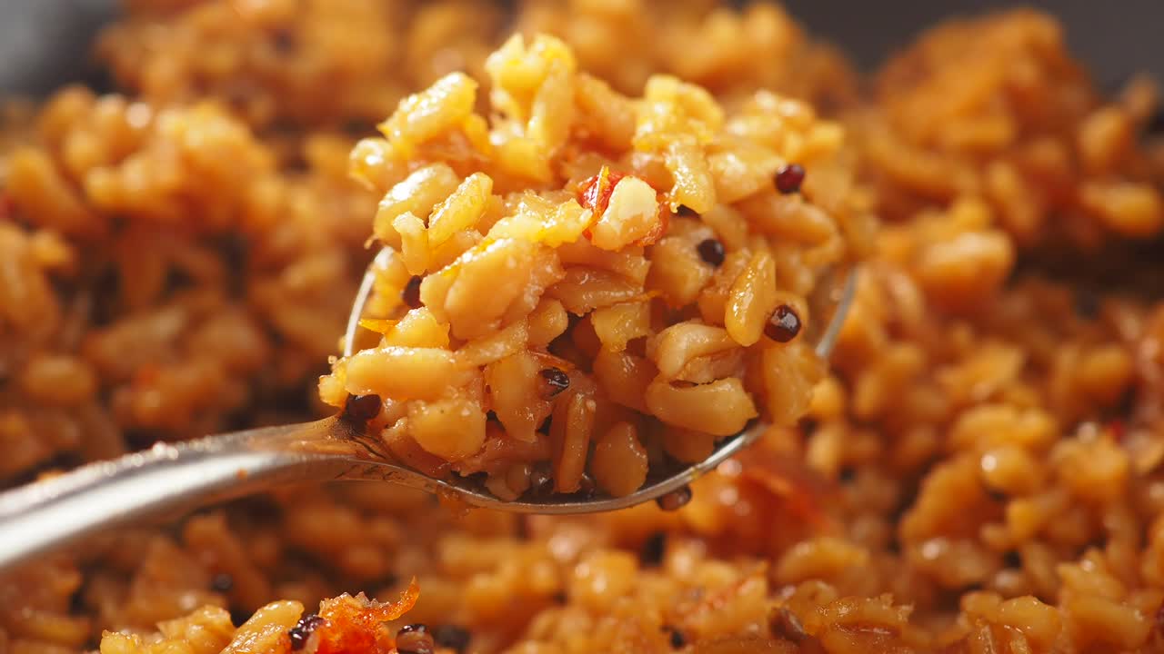 Primer plano de arroz salado especiado servido en una cuchara