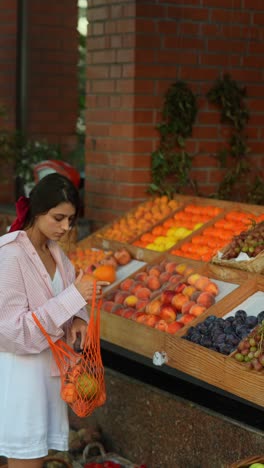 woman shopping for fruit at a market