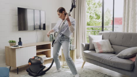 woman having fun while vacuuming