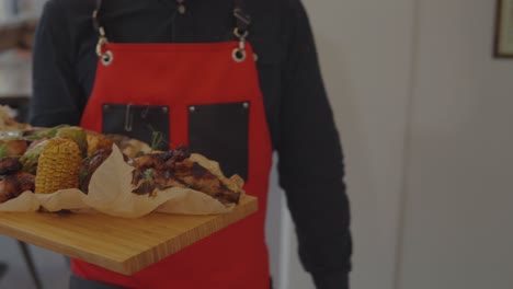 waiter serving a mixed grill platter