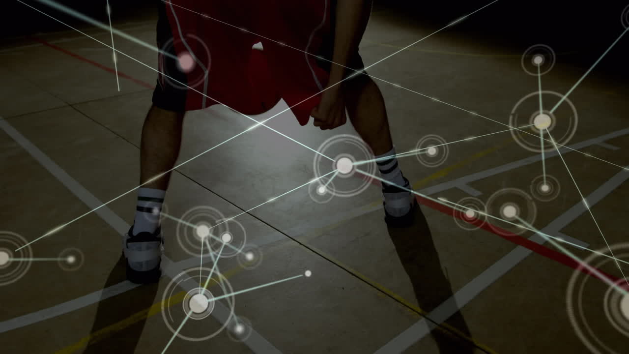 Animation of networks of connections over biracial male basketball player at gym