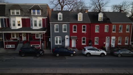 Aerial-truck-shot-of-colorful-row-houses-during-blue-hour-in-American-city