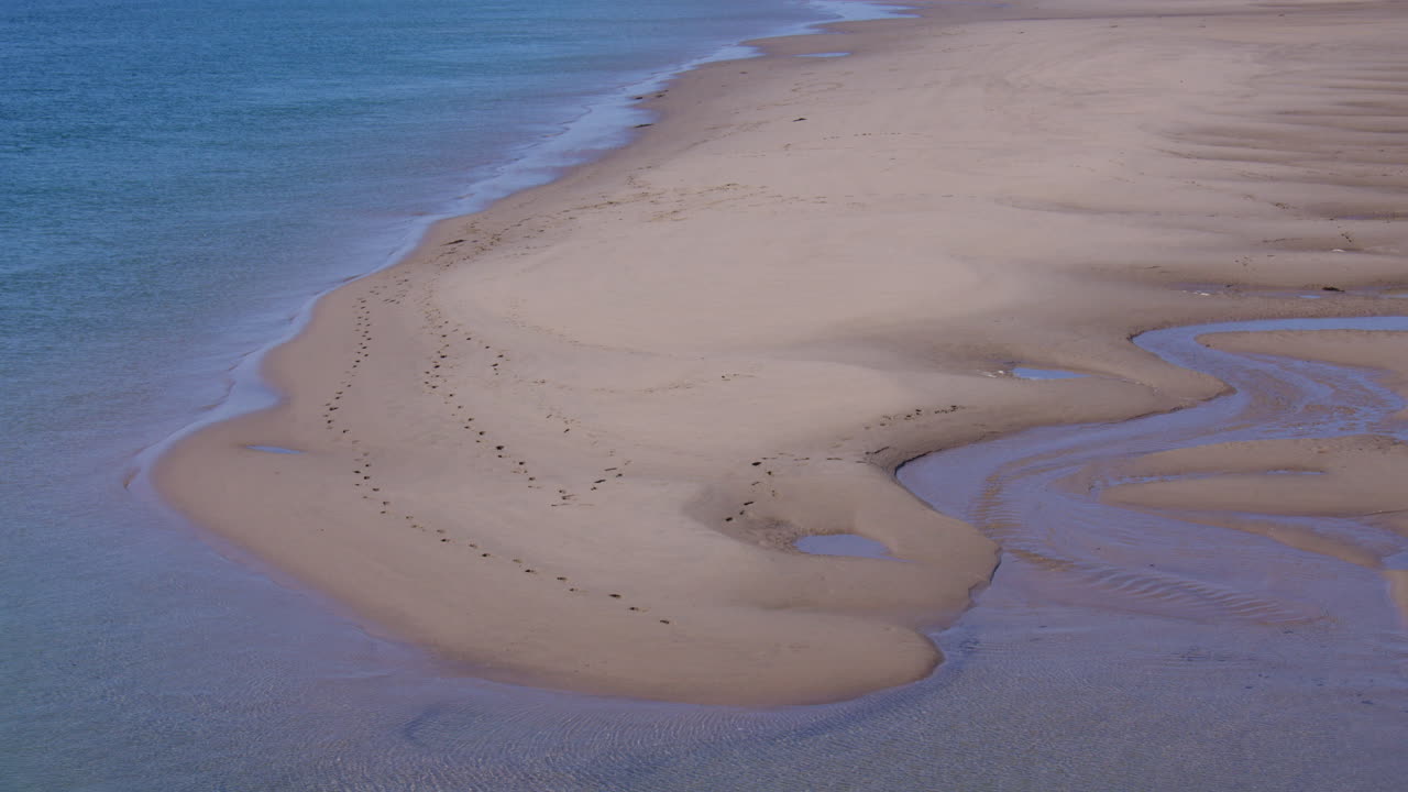 A shot of a sandbar at Traeth Abermaw, Beach at low tide at Barmouth