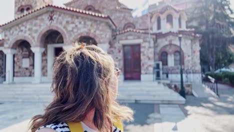 happy tourist woman taking selfie at a greek orthodox church