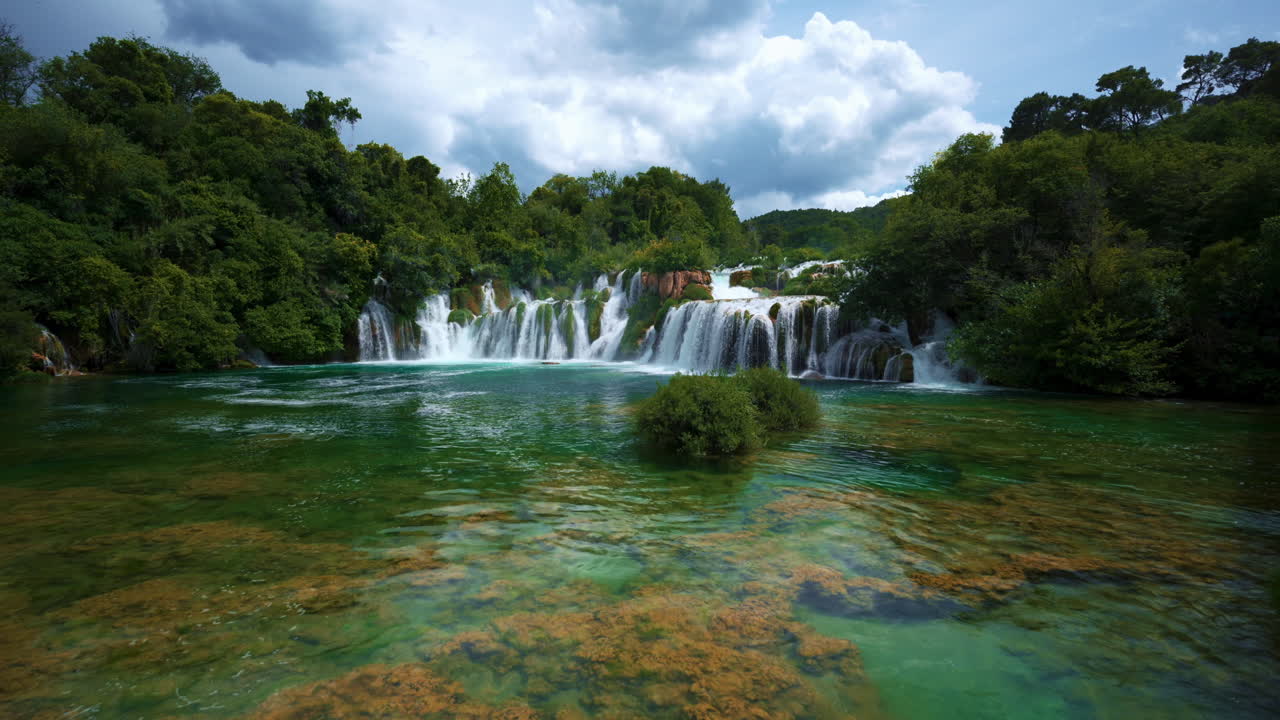 Idyllic waterfall cinemagraph with blue water cascades and vegetation, Krka National Park Croatia