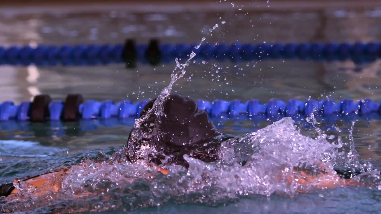Fit swimmer doing the front stroke in swimming pool