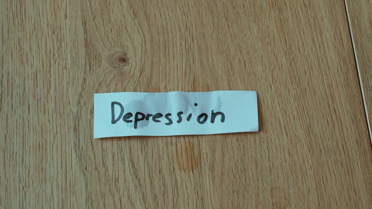 Paper labeled “Depression” with visible tear drops, symbolizing sadness, emotional struggle, and mental health awareness