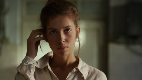 Young-woman-looking-at-camera-in-workshop