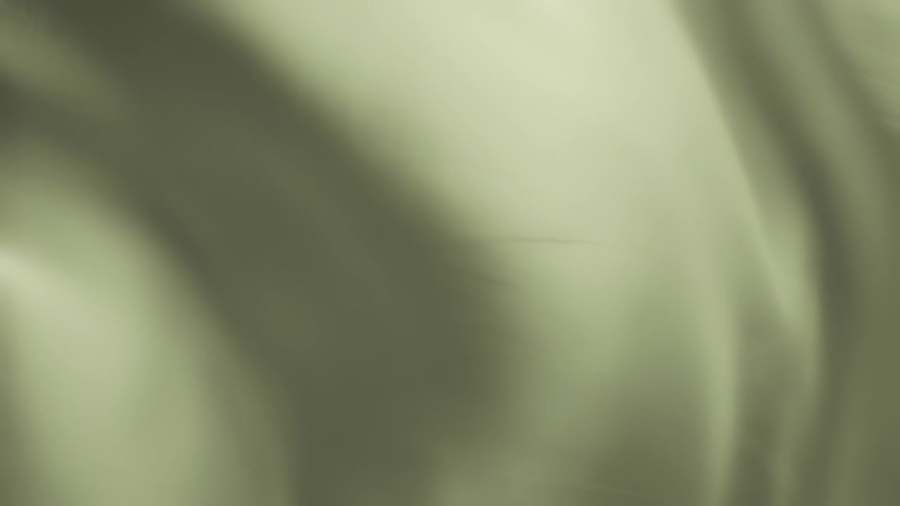 Silky pastel green fabric waving in the wind