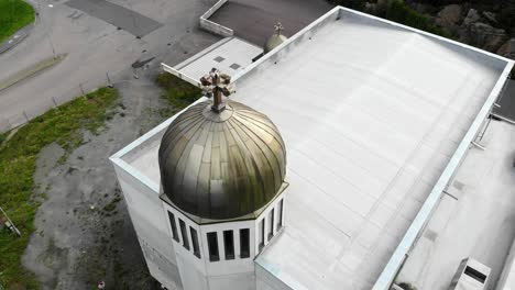 aerial circle pan around a golden sphere with cross on top of tower of church