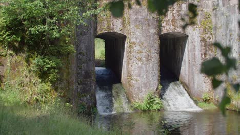 water flowing through stone archways