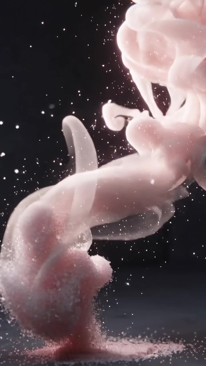 Video verticale: Pennacchio rosa che sale da un cumulo granulare, attorcigliandosi e rilasciando particelle in studio.