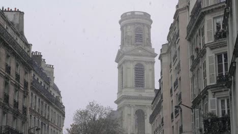 view of the tower of saint-sulpice church during a rare snowstorm