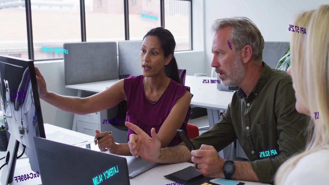 Woman pointing monitor causing overlays highlighting business chart while manager on phone deciding