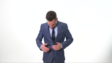 Young-Man-showing-thumbs-up-and-fixing-his-suit-while-smiling