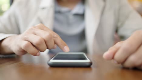 a young businessman wearing a surgical mask is taking a video conference with customers via a smart phone connected to the internet.