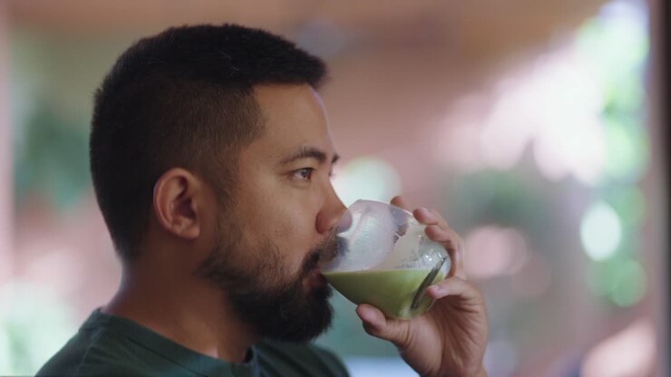 Man drinking matcha latte