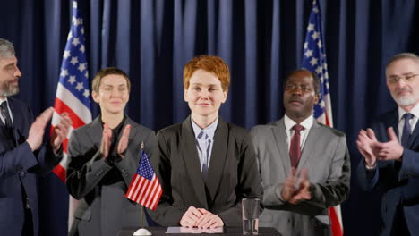 female politician making public announcement and smiling