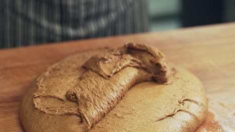 teaching rye dough on a wooden table top