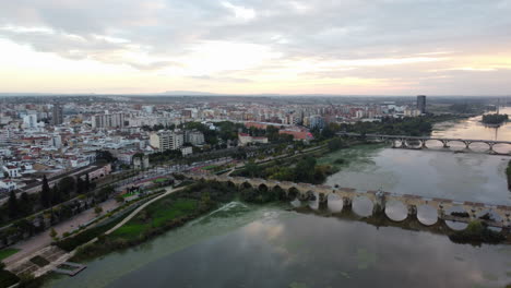 establishing aerial view of badajos and the bridge of palms at sunset