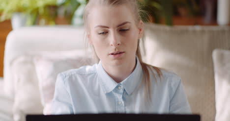 Smiling-Woman-Working-On-Laptop-