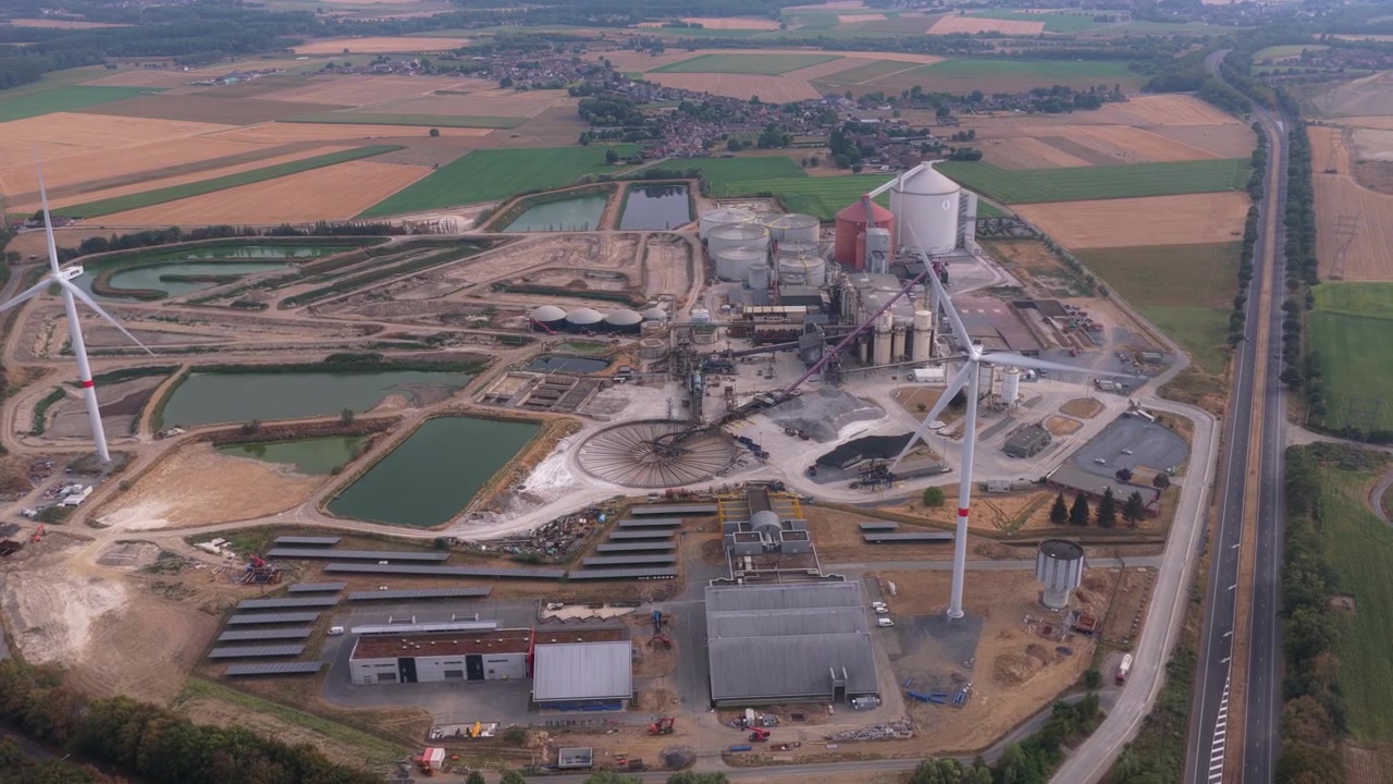 Aerial View of Industrial Factory Complex with Wind Turbines