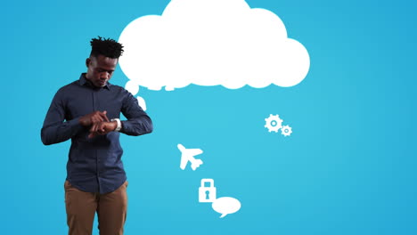 hombre afroamericano usando su reloj con iconos de fondo