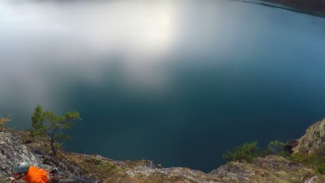 Rock-climber-climbing-the-cliff-against-the-sea-4k