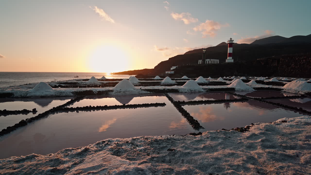 Salt flats at Fuencaliente with lighthouse during sunset, serene mood