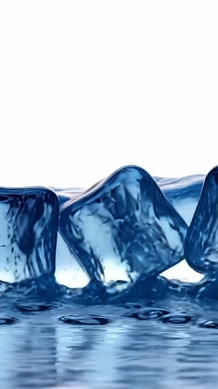 Ice cubes resting on water surface. Clear ice cubes sit on a reflective surface, capturing light and creating a serene, refreshing atmosphere.