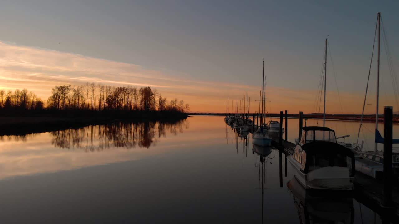 Drone 4K Footage Historic Stewart Farm Low Flying Dark Dusk Sunset over water passing by moored boats along Docking station