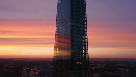 modern glass skyscraper at sunset