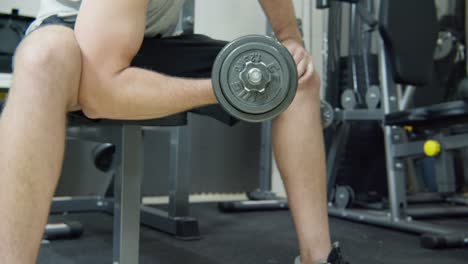 close up on a man exercising with a dumbbell