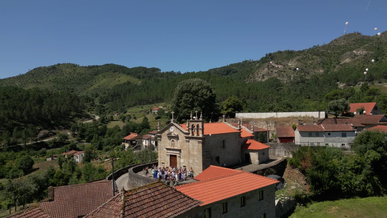 Church gathering with balloons released into sky near Cabril village, Montalegre