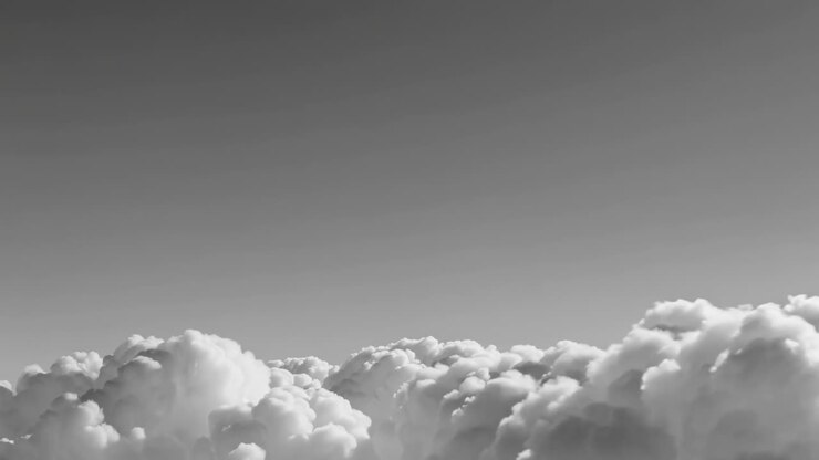 Aerial video captures a serene, monochrome cloudscape from a high angle, emphasizing the fluffy