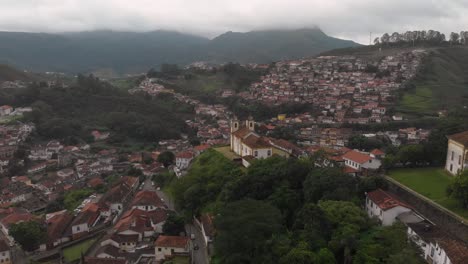 aerial view of ouro preto, minas gerais, brazil, starting from the our lady of conception to our lady of mercy and pardon and revealing fransisco de assisi churches on an overcast morning day