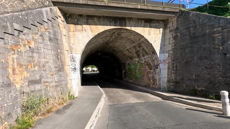 a tunnel with graffiti and road in libourne