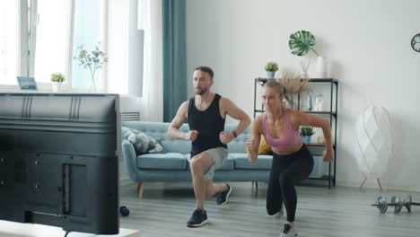 couple doing online exercise routine at home