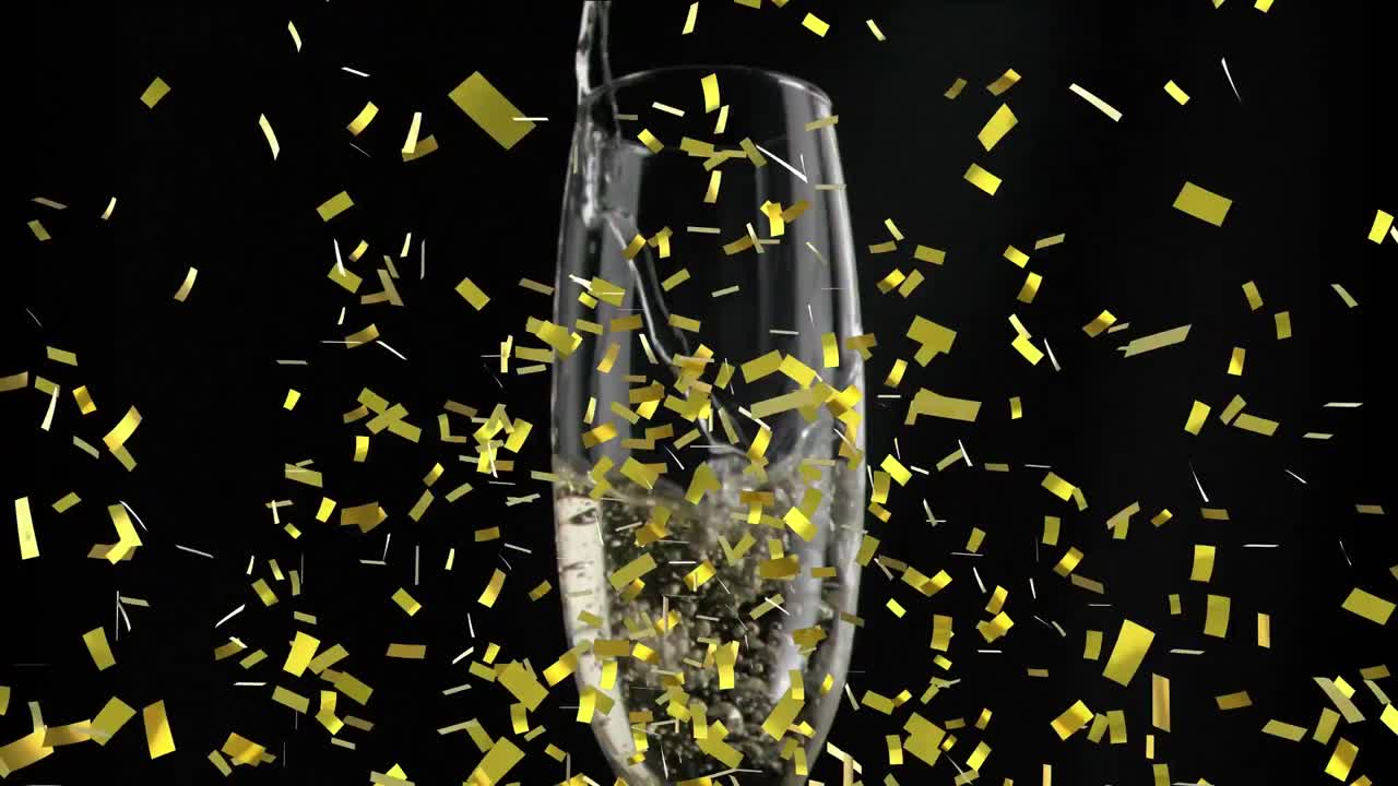 검은색 바탕에  ⁇ 페인 잔 위에 떨어지는 금색 콘페티의 애니메이션