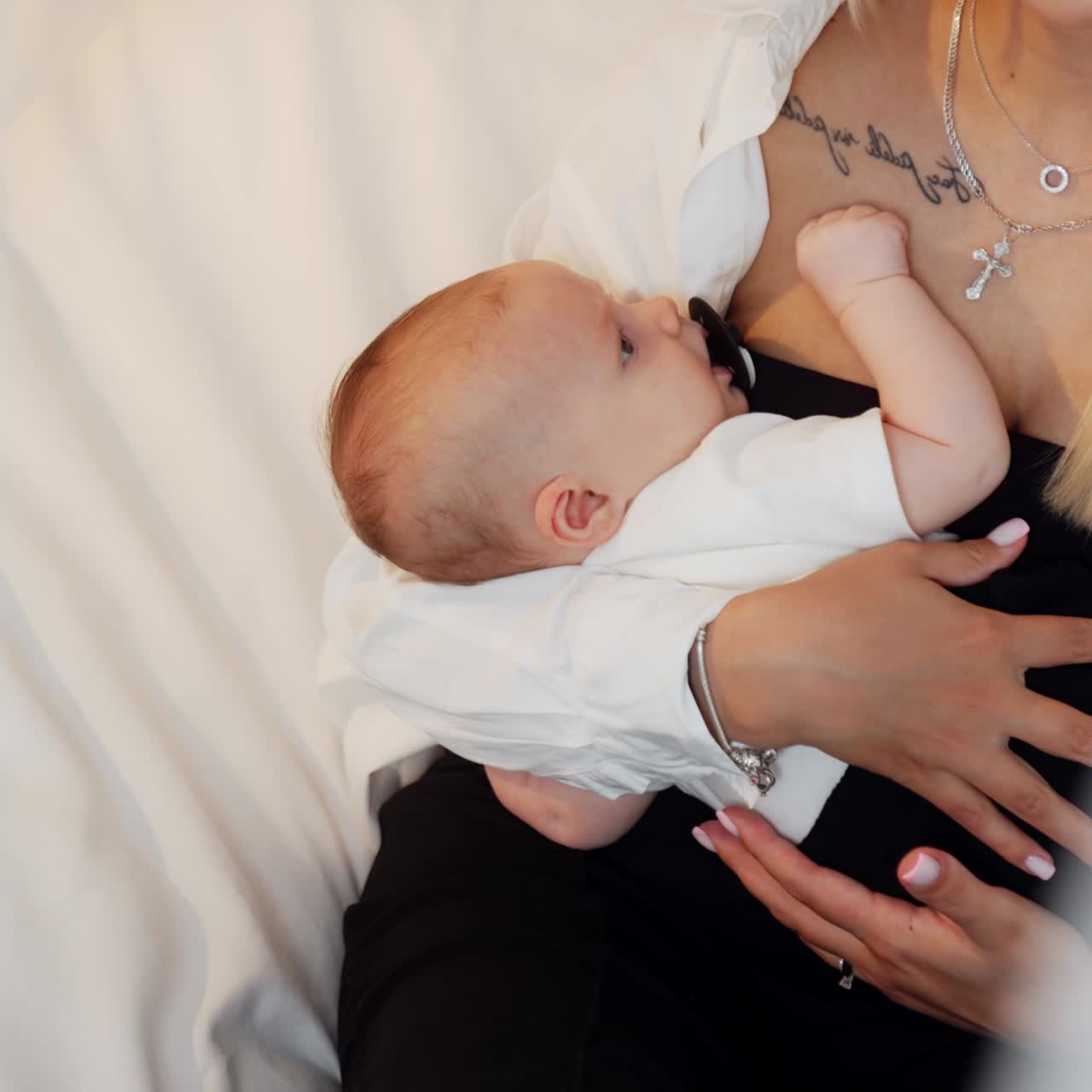 Small newborn baby on parents hands. Little child motherhood