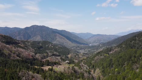 aerial view of tsumago-juku to magoma hiking section in kiso valley, japan. ascending dolly forward shot