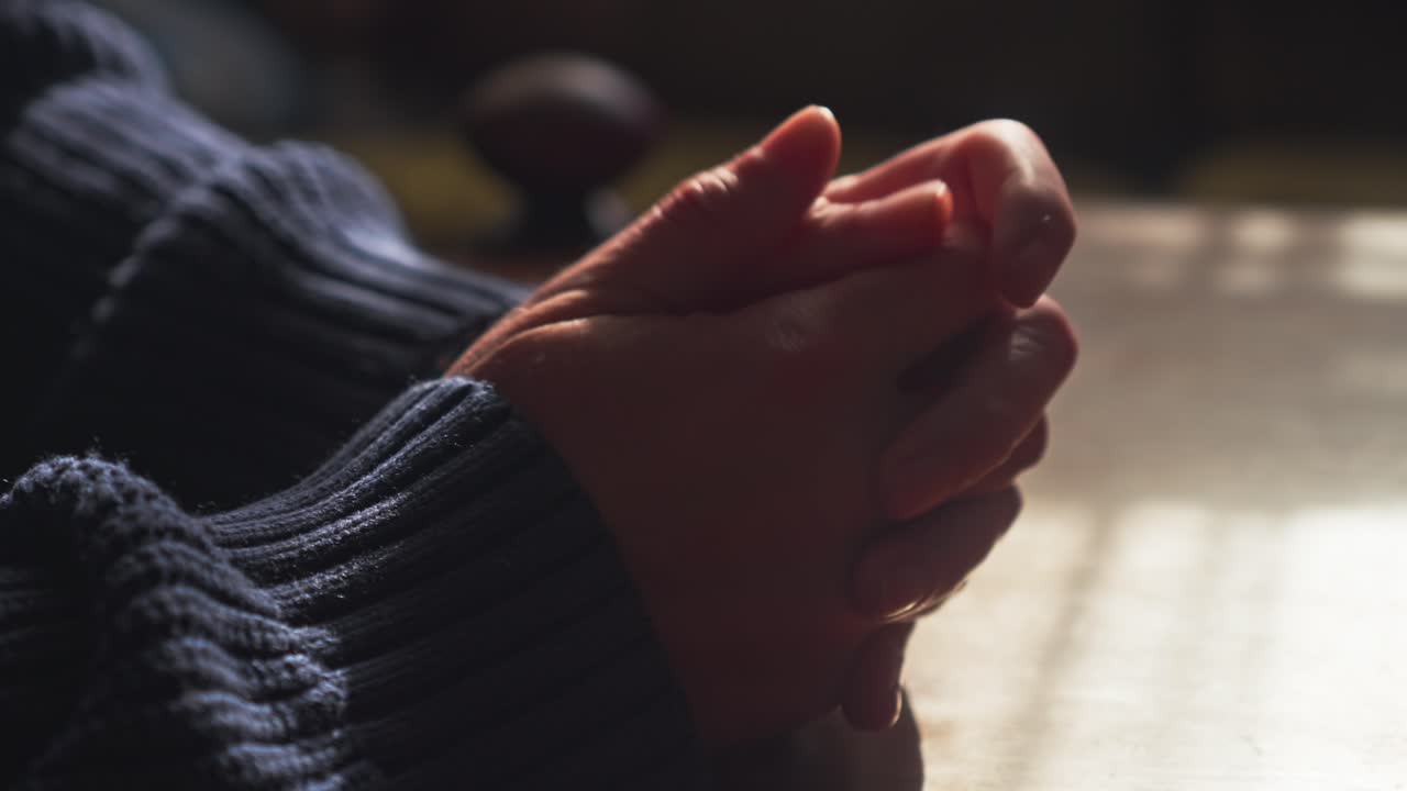 Restless anxious hands rubbing, clasping, nervously in room close-up