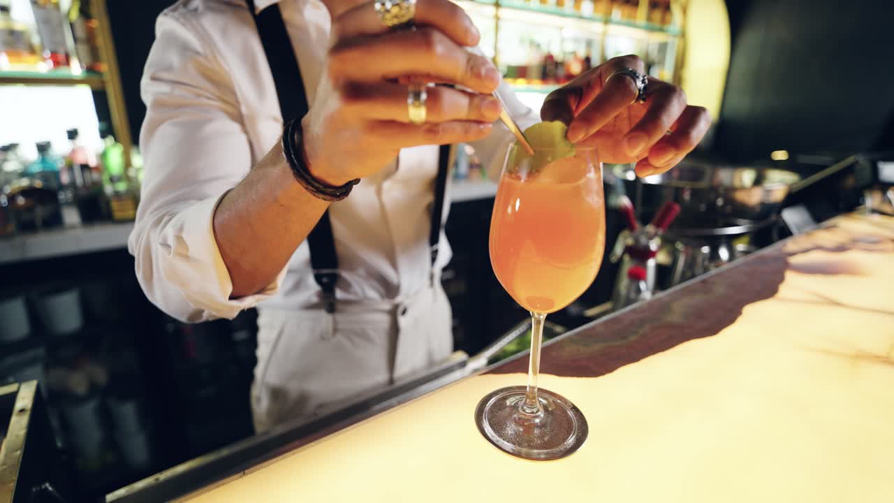 Bartender Garnishing a Fresh Cocktail with a Lime Wedge