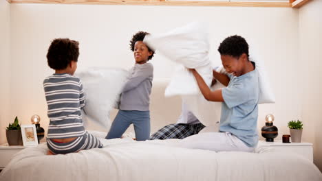 Family,-pillow-fight-and-playing-on-bed