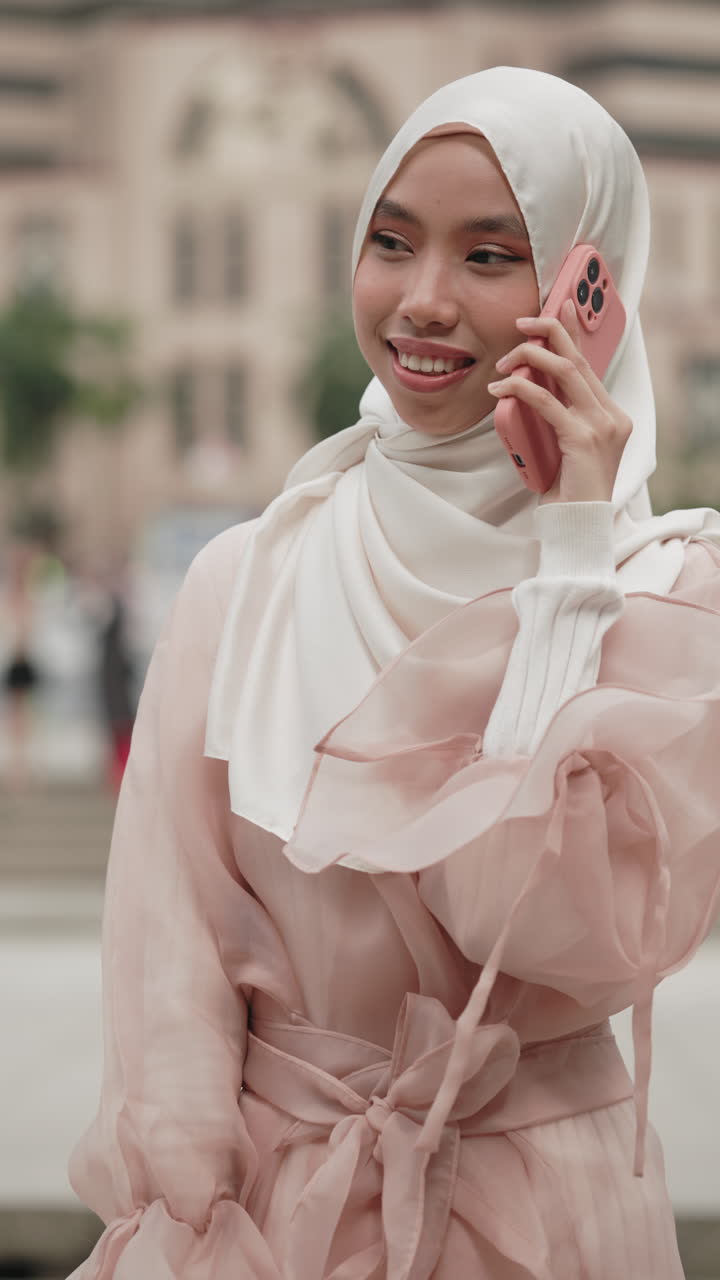 Woman talking on phone in a city