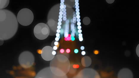 animation of spots of light over christmas city lights