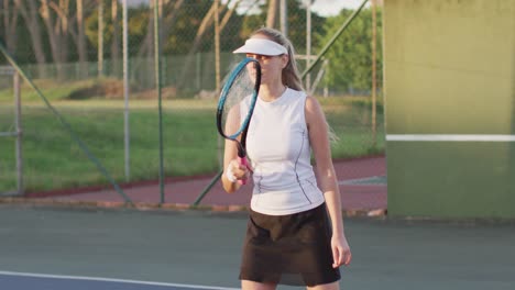 video of focused caucasian female tennis player holding racket and hitting ball