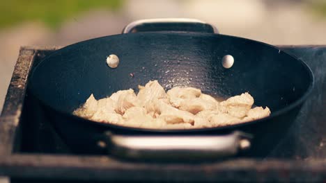 Close-up-Slow-motion-Meat-is-roasted-in-a-cauldron-on-coals-on-a-brazier-in-oil