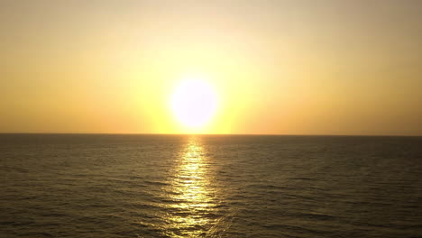 isolated big yellow and orange sun reflecting in the water