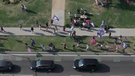 birds-eye aerial view over crowd with support for donald trump for president as cars line up